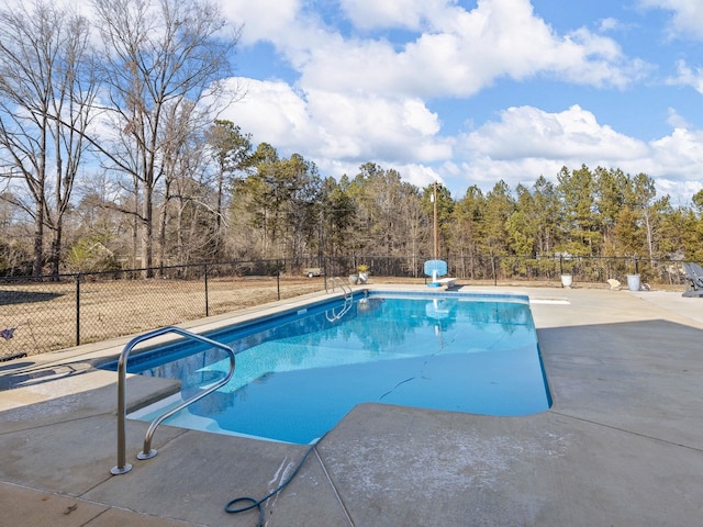 view of swimming pool featuring a diving board and a patio area