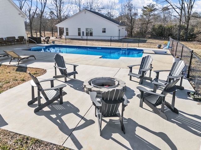 view of pool with a patio area and a fire pit