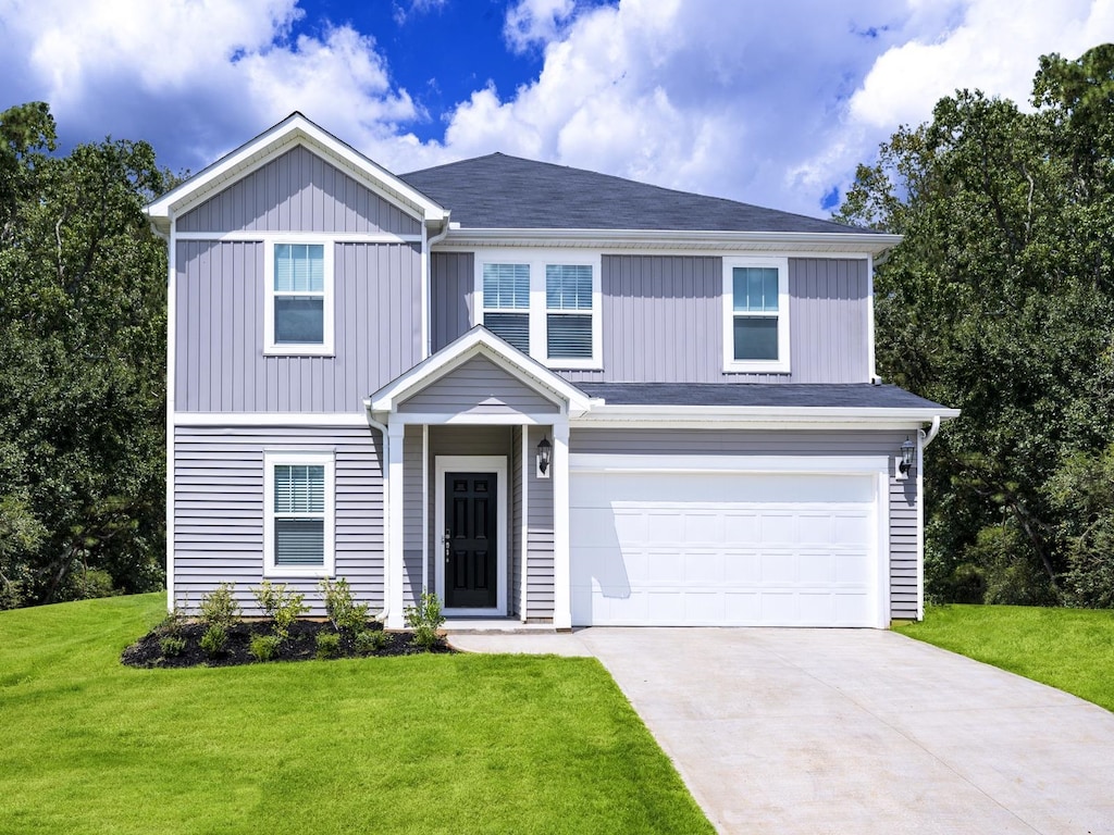 view of front of home featuring a garage and a front lawn