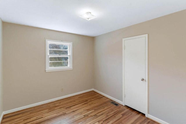 empty room with light hardwood / wood-style flooring