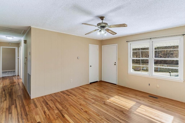 empty room featuring a textured ceiling and light wood-type flooring