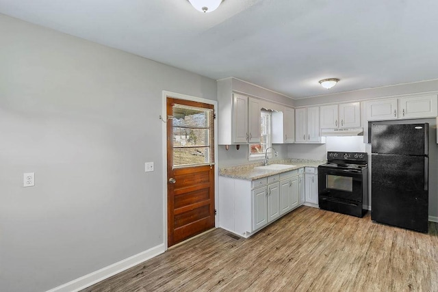 kitchen with white cabinets, sink, light hardwood / wood-style flooring, and black appliances