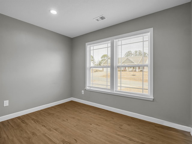 unfurnished room featuring hardwood / wood-style floors