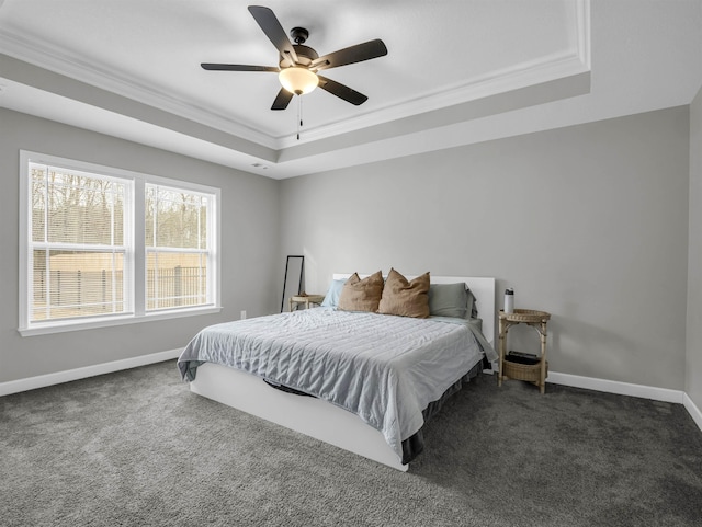 carpeted bedroom featuring crown molding, a tray ceiling, and ceiling fan