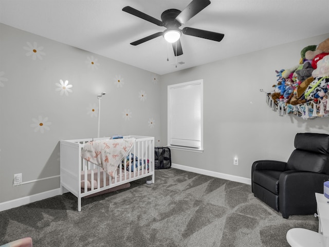 carpeted bedroom with ceiling fan and a crib