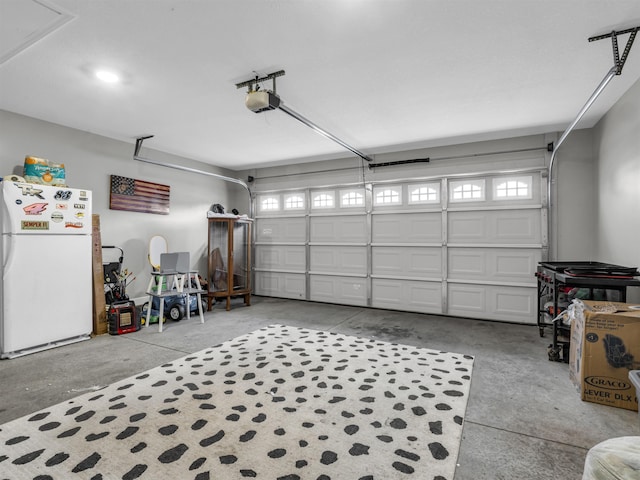 garage with a garage door opener and white fridge