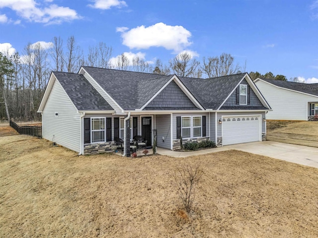 craftsman-style house featuring a porch, a garage, and a front yard