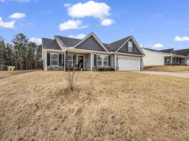 view of front of property featuring a garage and a front lawn