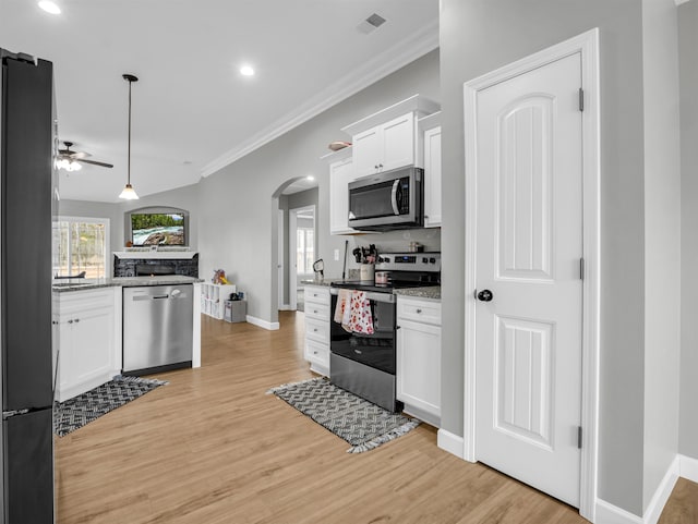 kitchen featuring light hardwood / wood-style flooring, appliances with stainless steel finishes, hanging light fixtures, white cabinets, and stone countertops