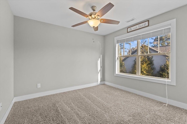 unfurnished room featuring ceiling fan and carpet