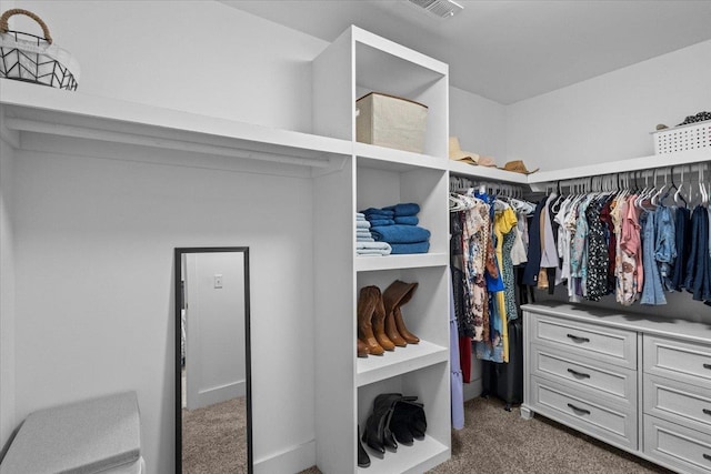 spacious closet with dark colored carpet