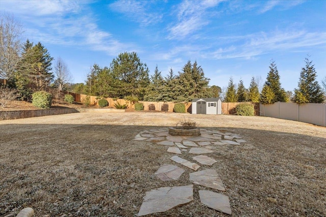 view of yard featuring a shed and a fire pit