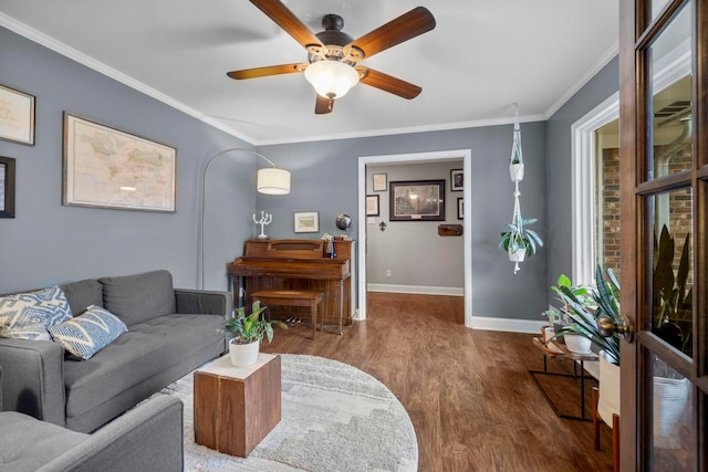 living room featuring hardwood / wood-style flooring, crown molding, a wealth of natural light, and ceiling fan