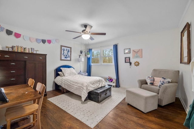 bedroom with crown molding, dark wood-type flooring, and ceiling fan