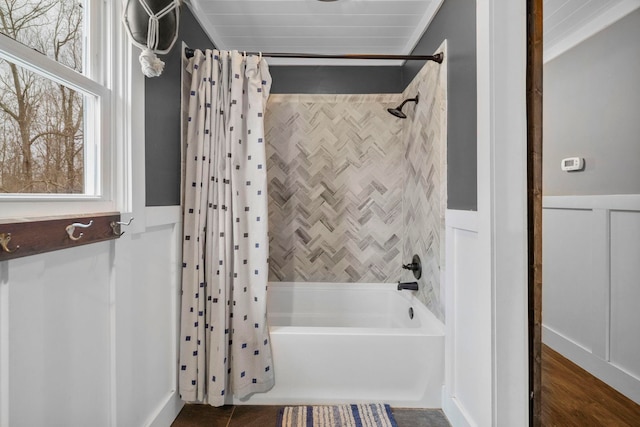 bathroom with shower / bath combo with shower curtain