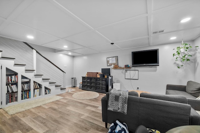 living room with coffered ceiling and hardwood / wood-style floors