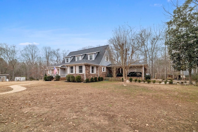 cape cod-style house with covered porch and a front yard