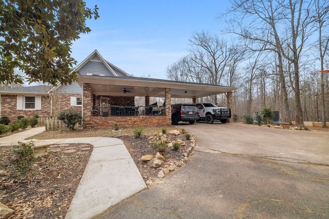 view of parking featuring ceiling fan and a carport