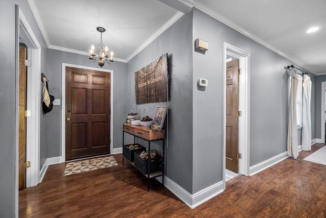 entrance foyer with crown molding, dark hardwood / wood-style floors, and a chandelier