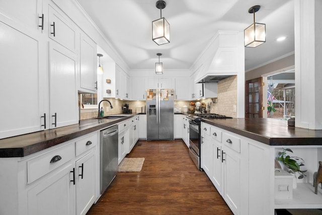 kitchen with white cabinetry, sink, tasteful backsplash, and appliances with stainless steel finishes