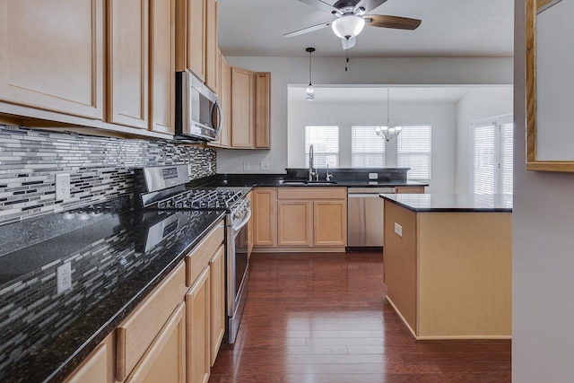 kitchen with sink, appliances with stainless steel finishes, hanging light fixtures, dark hardwood / wood-style flooring, and light brown cabinets