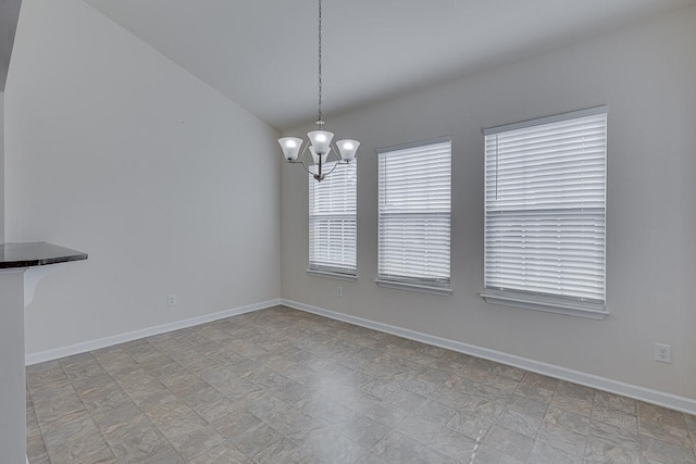 unfurnished dining area with an inviting chandelier