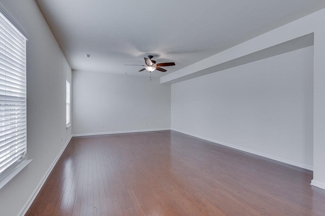 unfurnished room with ceiling fan and dark hardwood / wood-style floors