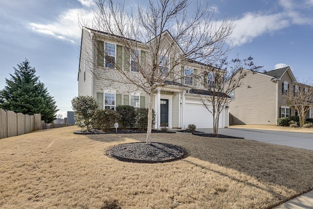 view of property featuring a garage and a front yard