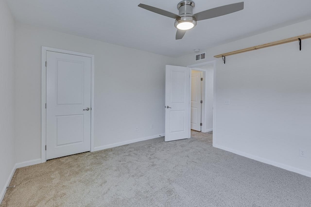 spare room with light carpet and ceiling fan