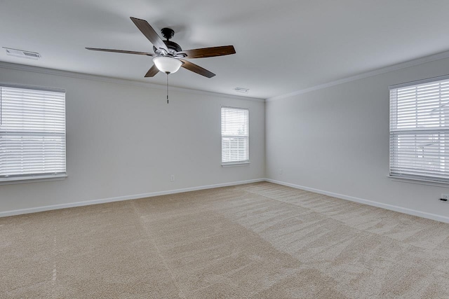 carpeted spare room with crown molding and ceiling fan