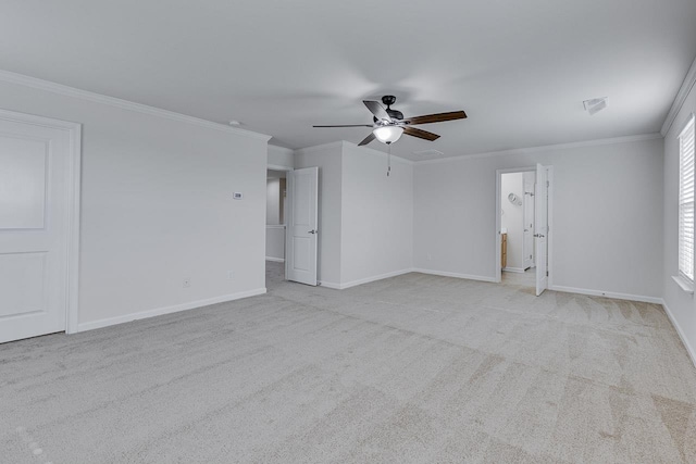 carpeted empty room featuring crown molding and ceiling fan