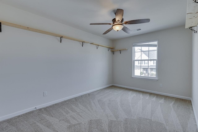 spare room with carpet flooring and ceiling fan