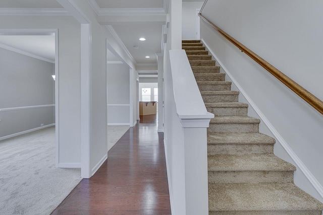 stairs featuring ornamental molding and hardwood / wood-style floors