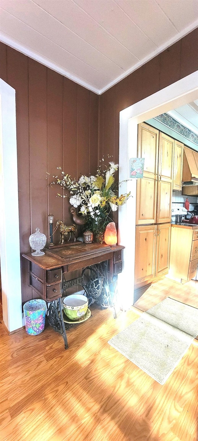 interior space with hardwood / wood-style flooring and wooden walls