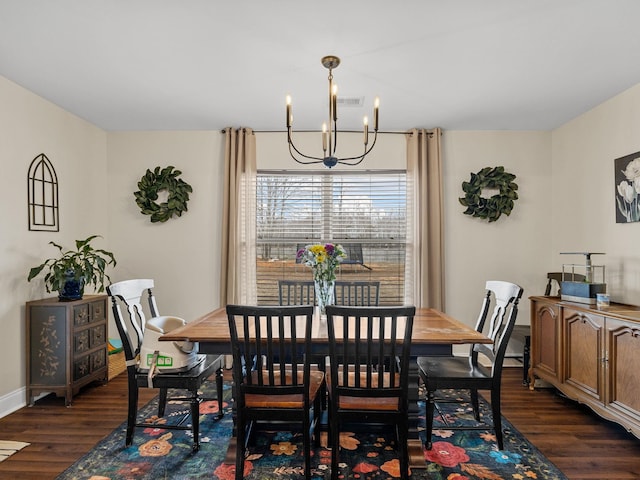 dining space with a chandelier and dark hardwood / wood-style flooring