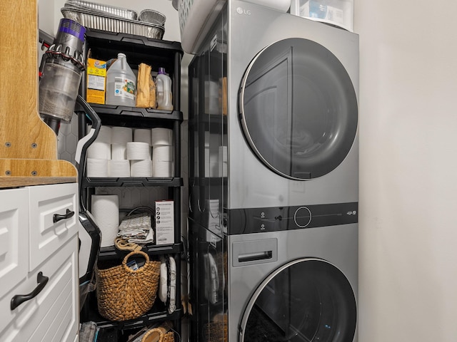 clothes washing area with stacked washer and clothes dryer