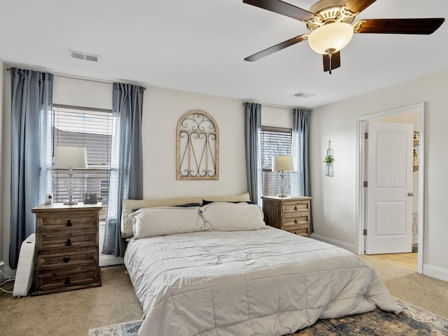 bedroom with ceiling fan and light carpet