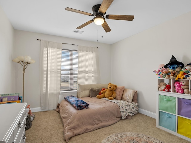 bedroom featuring light colored carpet and ceiling fan