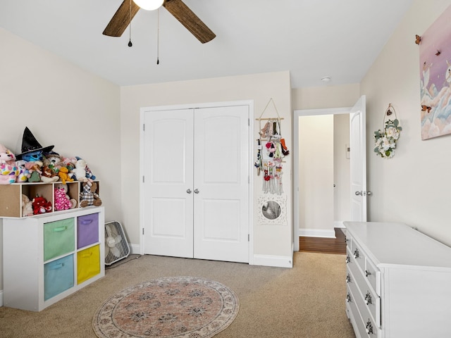 rec room featuring light colored carpet and ceiling fan