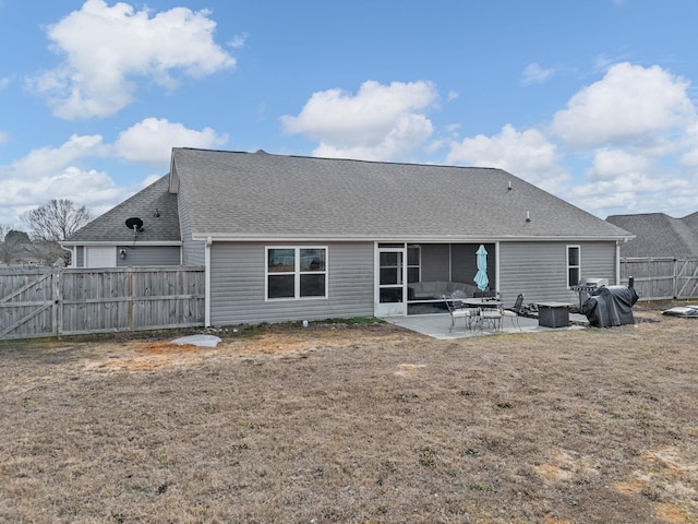 rear view of house with a patio and a lawn