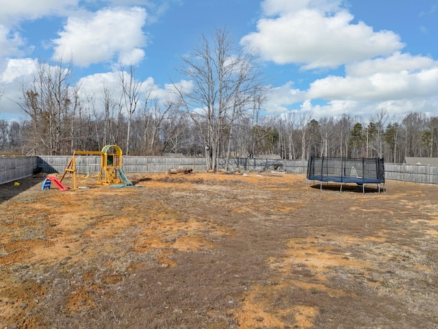 view of yard featuring a playground and a trampoline