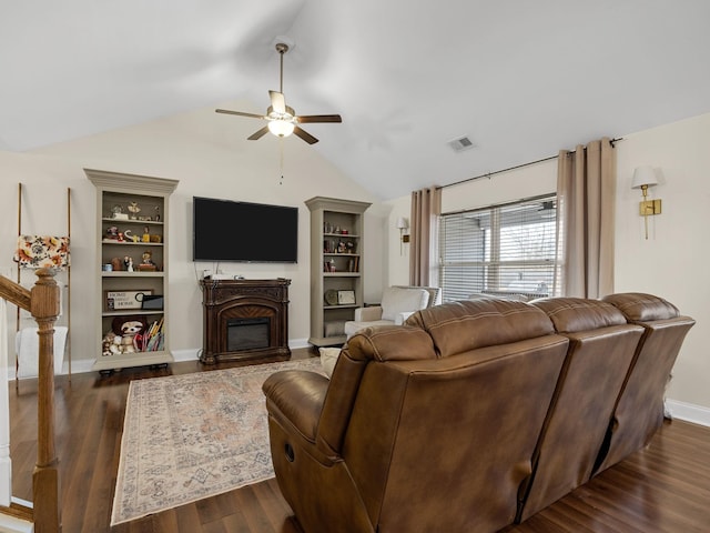 living room featuring dark wood-type flooring, ceiling fan, lofted ceiling, and built in features