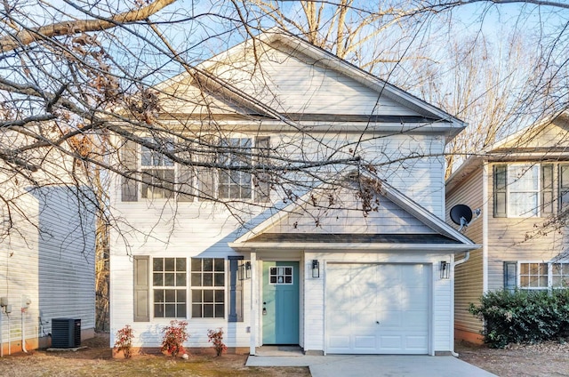 view of front of property featuring a garage and central AC