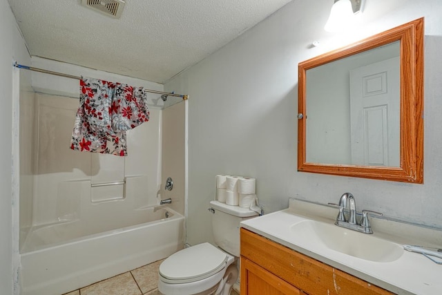 full bathroom featuring tile patterned flooring, vanity, a textured ceiling, shower / washtub combination, and toilet