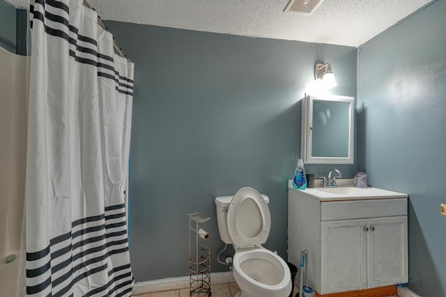 bathroom featuring vanity, a textured ceiling, curtained shower, tile patterned floors, and toilet