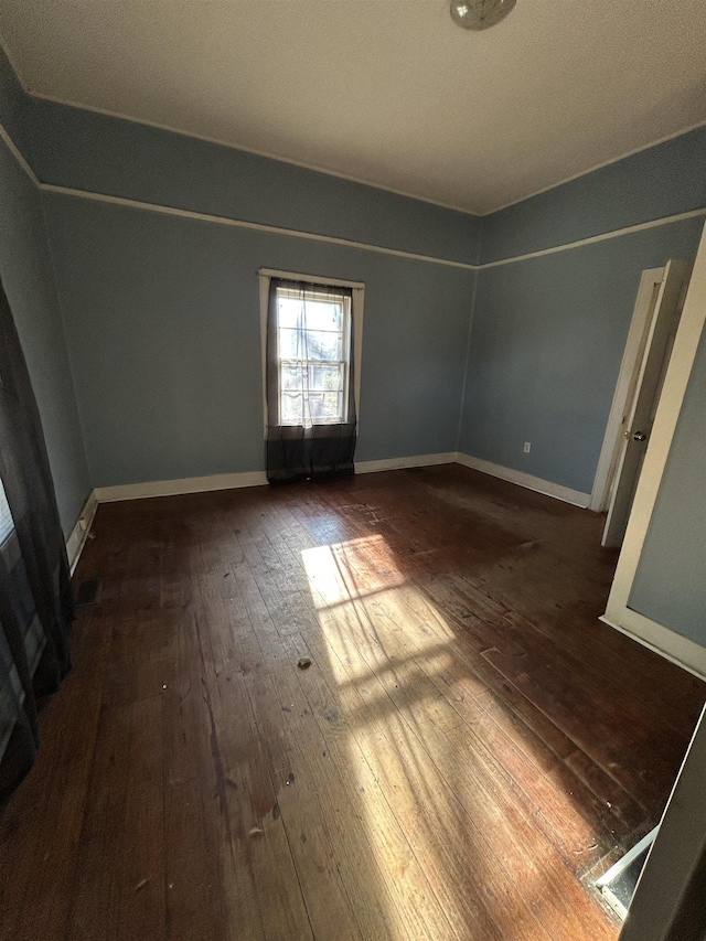 empty room with dark hardwood / wood-style floors