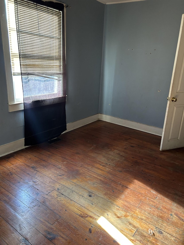 spare room with dark hardwood / wood-style floors