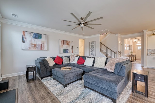 living room with ceiling fan, wood-type flooring, and ornamental molding