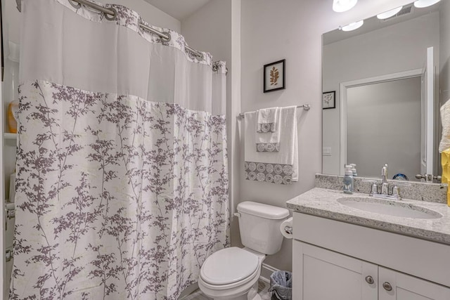 bathroom featuring vanity, toilet, and a shower with shower curtain