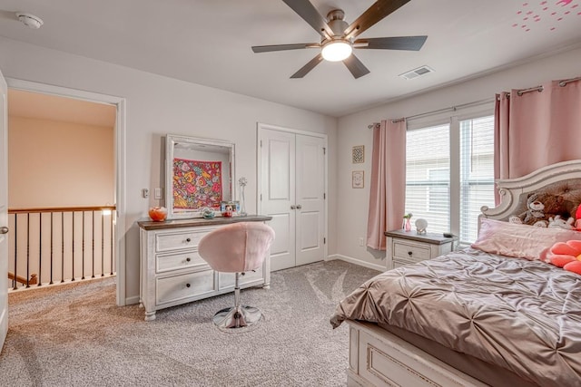 carpeted bedroom with a closet and ceiling fan